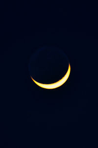 Low angle view of moon against black background