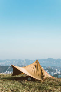 Tent on field against clear sky