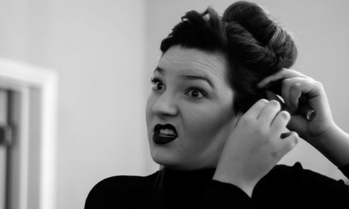 Woman making hairstyle at home