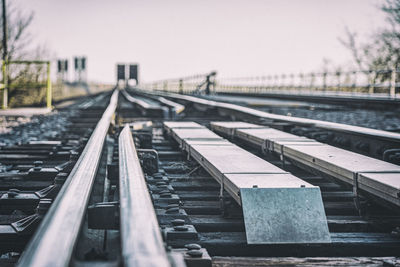 Close-up of railroad tracks against clear sky