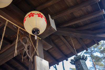 Low angle view of lantern hanging against building