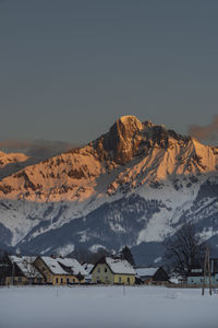 Scenic view of snowcapped mountains against sky during sunset