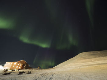 Scenic view of illuminated landscape against sky at night