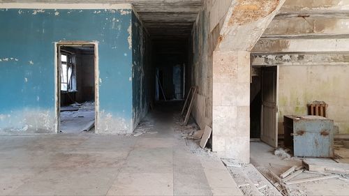 Abandoned building with colorful walls and some debris in the radioactive city of prypiat