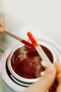 Close-up of hand holding tea cup