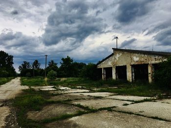 Abandoned building on field against sky