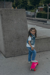 Full length of girl standing on footpath