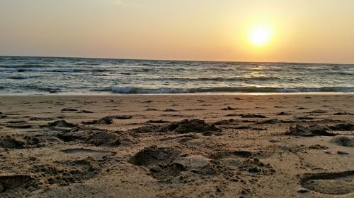 Scenic view of beach against sky during sunset