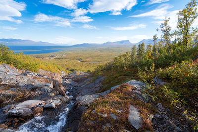 Scenic view of waterfall against sky