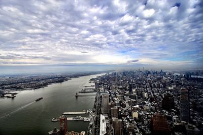 High angle view of buildings by city against sky