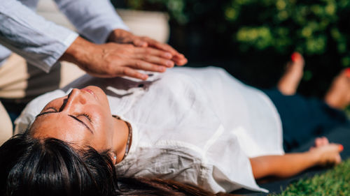 Woman in reiki spiritual healing session. 