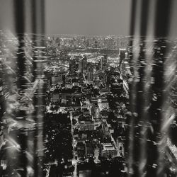 Aerial view of illuminated buildings in city at night