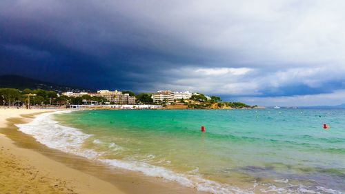 View of beach against cloudy sky