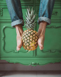 Midsection of man holding fruit