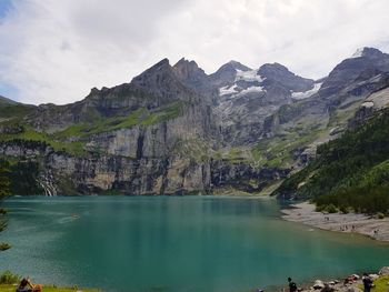 Scenic view of lake and mountains against sky