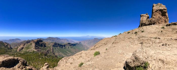 Scenic view of mountains against blue sky