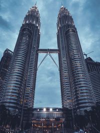 Low angle view of buildings against cloudy sky