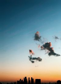 Low angle view of silhouette buildings against sky during sunset