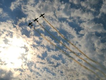 Low angle view of airplane flying against sky