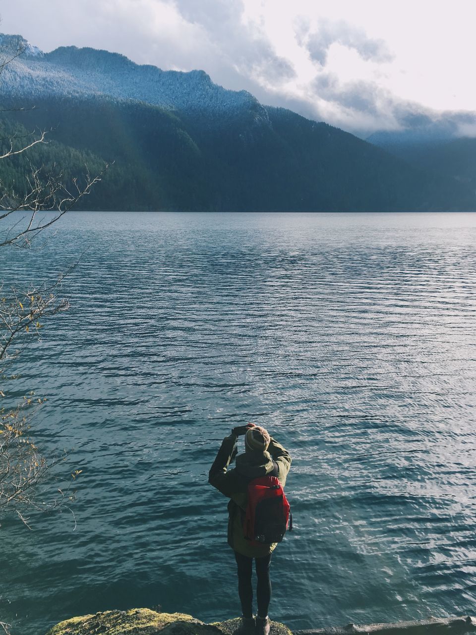 water, mountain, lifestyles, leisure activity, rear view, scenics, tranquil scene, tranquility, lake, beauty in nature, standing, nature, sky, casual clothing, mountain range, full length, men, idyllic