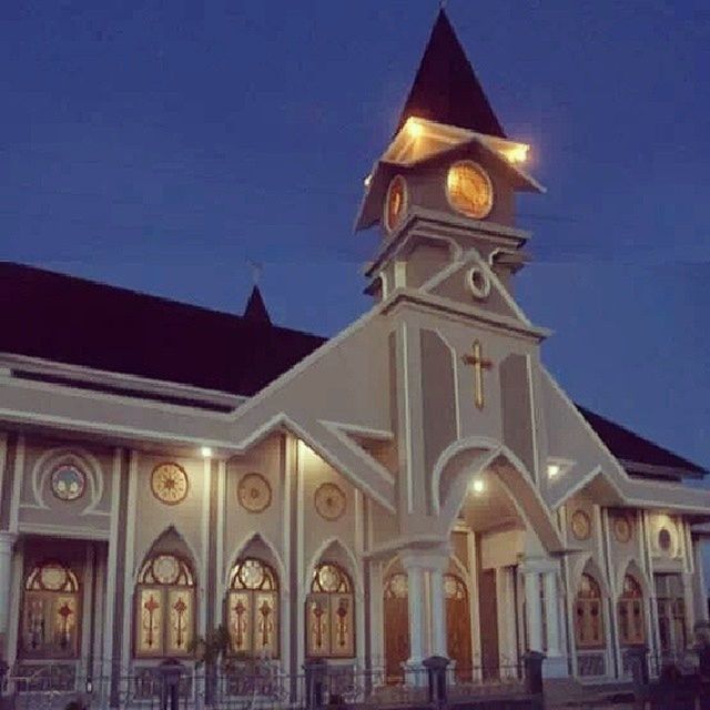 religion, building exterior, architecture, place of worship, church, spirituality, built structure, low angle view, cathedral, illuminated, clear sky, cross, night, blue, sky, street light, facade, dome