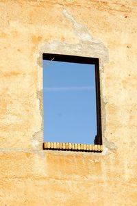 Low angle view of window on wall of building