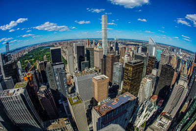 Aerial view of modern buildings against cloudy sky