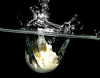 Close-up of splashing water over black background