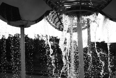 Low angle view of water drops on glass window