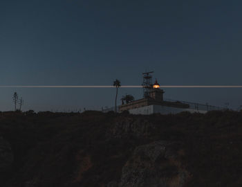 Low angle view of silhouette tower against sky at sunset
