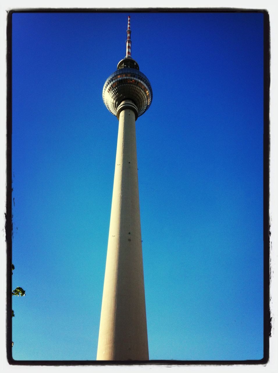 communications tower, tower, tall - high, architecture, built structure, television tower, fernsehturm, international landmark, communication, low angle view, spire, famous place, building exterior, tourism, travel destinations, capital cities, clear sky, blue, culture, travel