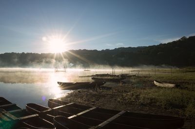 Scenic view of lake against bright sun