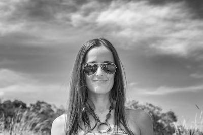 Portrait of smiling woman against sky