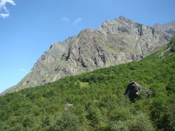 Scenic view of rocky mountains against blue sky