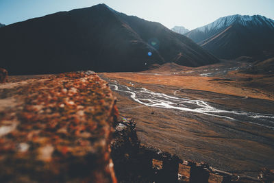 Scenic view of river and mountains against sky