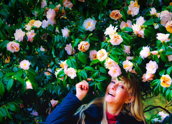 Portrait of smiling woman by flowering plants