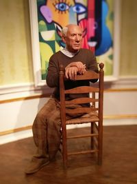 Man sitting on chair at home