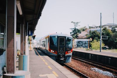 Train at railroad station against sky