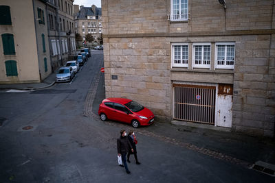 High angle view of man walking on street against building