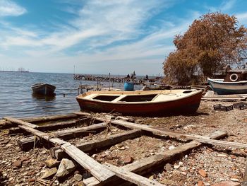 Boats moored on sea against sky