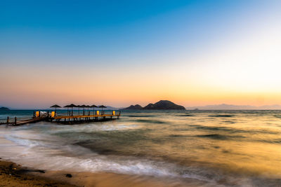 Scenic view of beach against sky during sunset