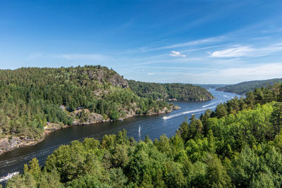 High angle view of river amidst trees against sky