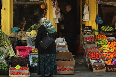 Women standing fruit stall