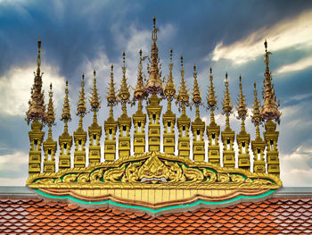 Sculpture of building against cloudy sky