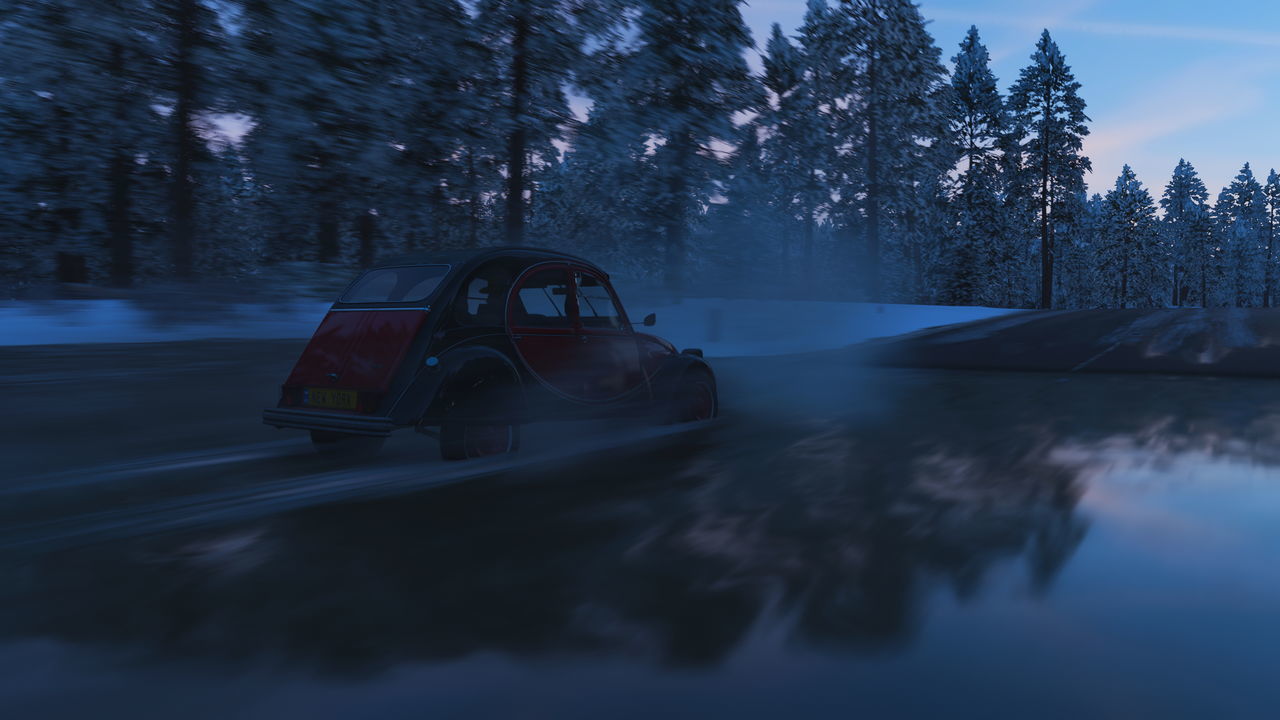 CAR ON SNOW COVERED LAND IN WINTER