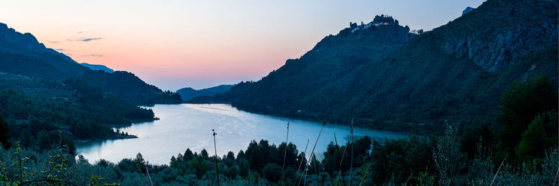 Scenic view of lake against sky during sunset