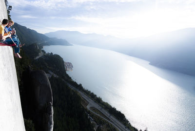 Two men laughing and smiling while drinking beer sunset on portaledge