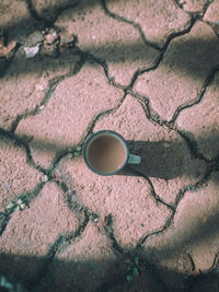 High angle view of coffee cup on floor