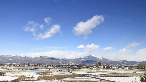 Scenic view of snowcapped mountains against blue sky