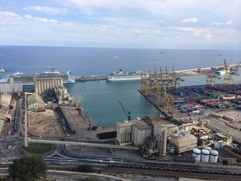 High angle view of cityscape by sea against sky